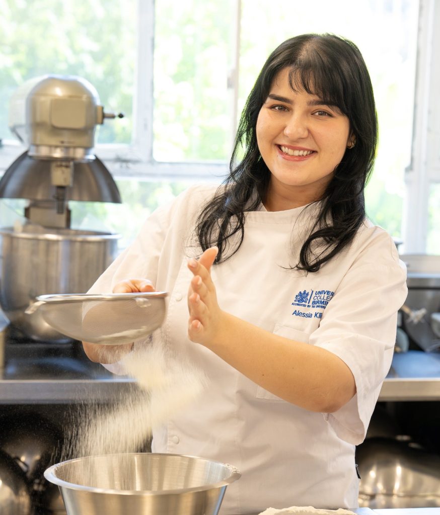 Woman sieving flour