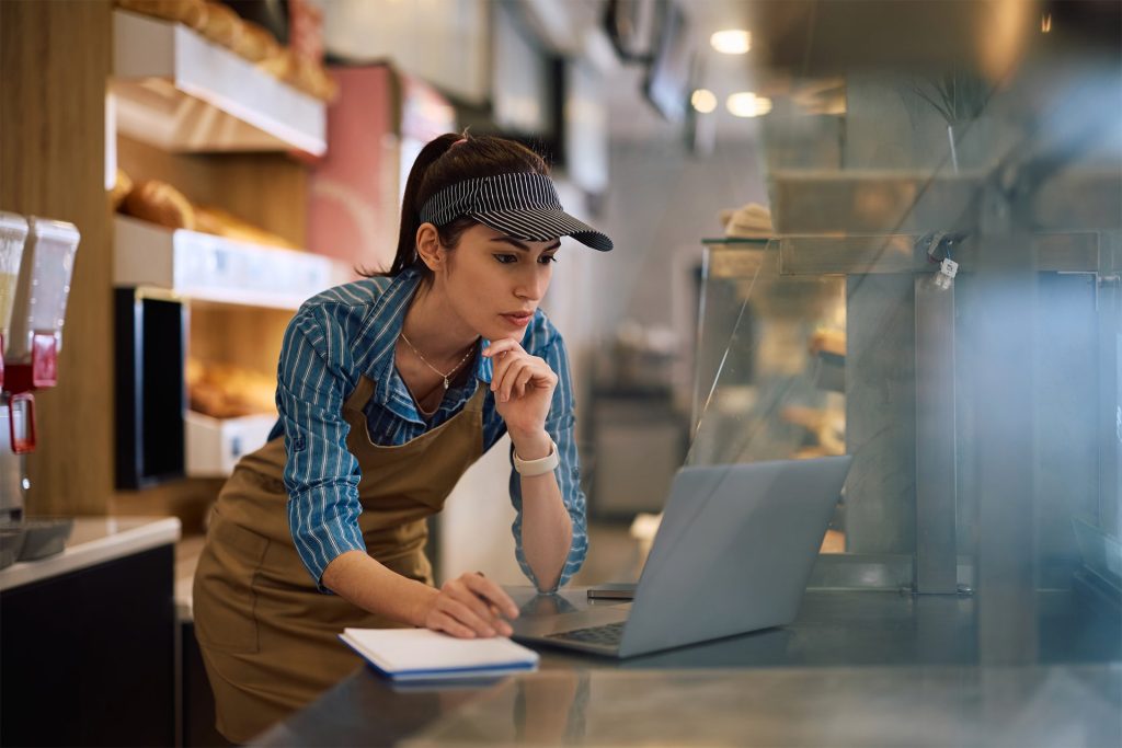 Female baker on laptop